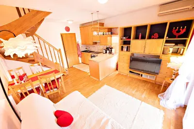 a kitchen and a living room with a dining room at Heart Bled in Bled
