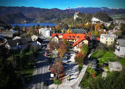 an aerial view of a small town with a parking lot at Heart Bled in Bled