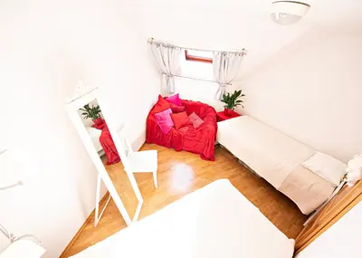 a small room with a bed and a mirror at Heart Bled in Bled