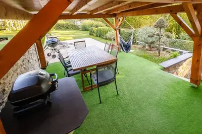 a patio with a table and chairs and a grill at Holiday Home Emaj with Sauna in Krška Vas