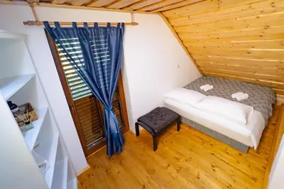 a small room with a bed and a window at Holiday Home Emaj with Sauna in Krška Vas