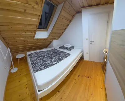 a bed in a room with a wooden ceiling at Holiday Home Emaj with Sauna in Krška Vas