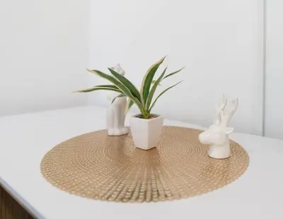 a table with two rabbits and a plant on it at Central Castle Apartments in Ljubljana