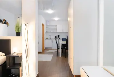 a living room with a bed and a kitchen at Central Castle Apartments in Ljubljana