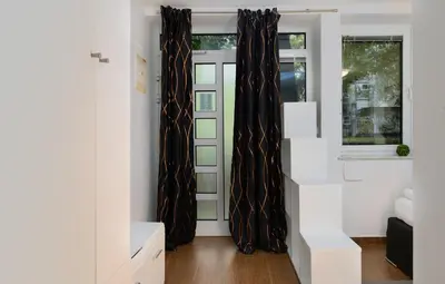 a hallway with black curtains in front of a door at Central Castle Apartments in Ljubljana