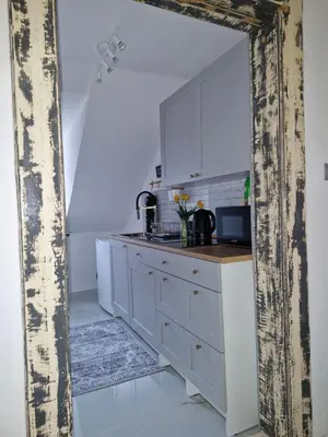 a kitchen with white cabinets and a sink at Apartma Nara in Ljubljana