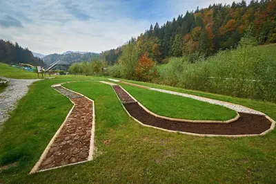 a garden with two pathways in the grass at Appartments Vrba, Terme Snovik in Laze v Tuhinju