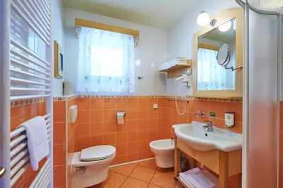 a bathroom with a sink and a toilet and a mirror at Appartments Vrba, Terme Snovik in Laze v Tuhinju