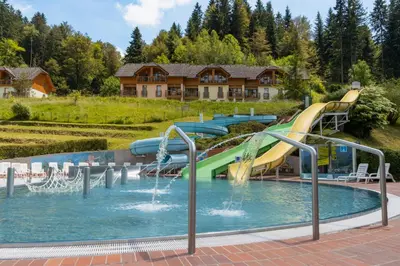 a pool with a water slide in a resort at Appartments Vrba, Terme Snovik in Laze v Tuhinju