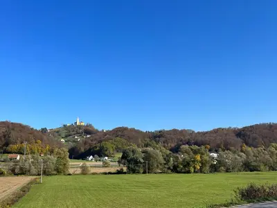 a green field with a hill in the background at Apartment Romeo & Julija, Near terme Olimia, Free Parking in Podčetrtek