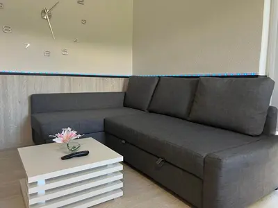 a living room with a couch and a table at Apartment Romeo & Julija, Near terme Olimia, Free Parking in Podčetrtek