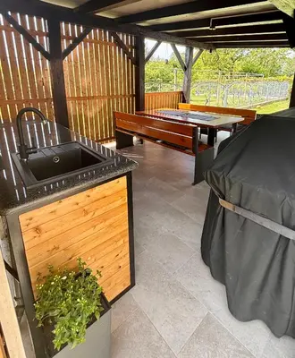 a patio with a grill and a pool table at Green Street Hideaway in Šempeter v Savinjski Dolini