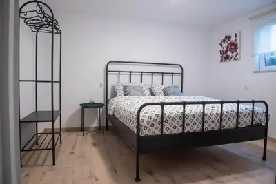 a bedroom with a bed with a metal frame at Green Street Hideaway in Šempeter v Savinjski Dolini