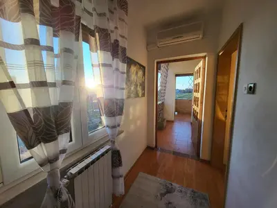 a hallway with a room with a window at Apartma ob meji in Šempeter pri Gorici
