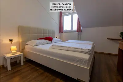 a large bed in a room with a window at Brezov kot in Jesenice