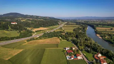an aerial view of a river and a town at Brezov kot in Jesenice