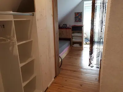 a room with a bedroom with a bed and a closet at Cottage Stela, family moutain hideout in Bohinj