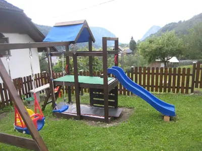 a playground with a slide and a slideintend at Cottage Stela, family moutain hideout in Bohinj