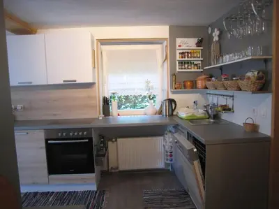 a kitchen with a counter top and a window at Cottage Stela, family moutain hideout in Bohinj