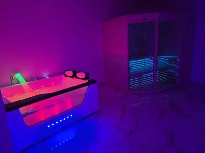 a bathroom with a tub with pink and purple lights at Lavitas Premium in Moravče