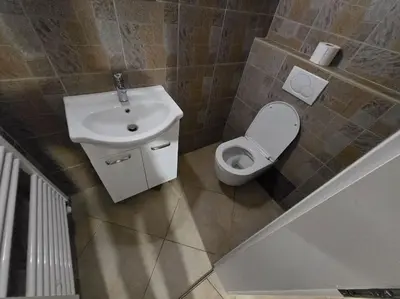 a small bathroom with a sink and a toilet at Lavitas Premium in Moravče