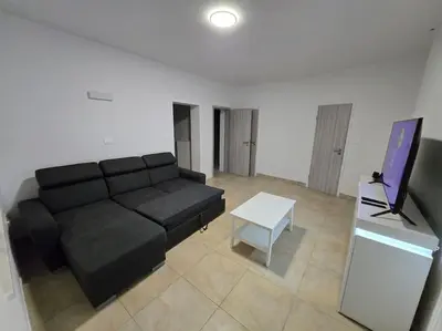 a living room with a black couch and a table at Lavitas Premium in Moravče