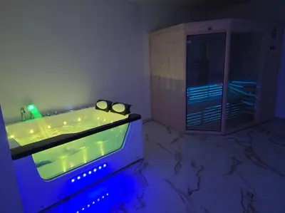 a bathroom with a tub with a pair of glasses in it at Lavitas Premium in Moravče