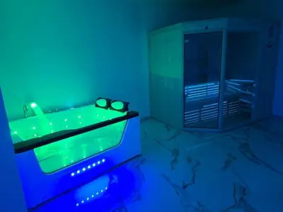 a blue room with a tub with glasses on it at Lavitas Premium in Moravče