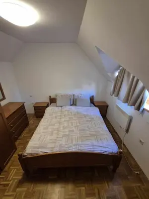 a bedroom with a large bed in a attic at Marjetjca 40 in Moravske Toplice