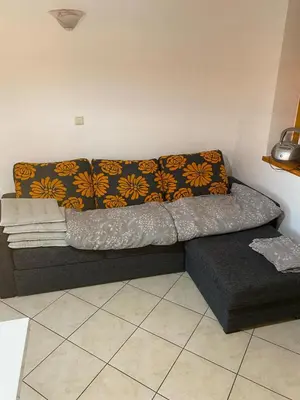 a couch in the corner of a room at Marjetjca 40 in Moravske Toplice