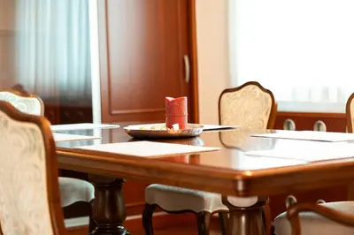 a wooden table with a bowl of food on it at Vila Majda Elegant Apartments with Prime Location and Parking in Ljubljana