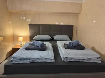 a bed with two pillows on it in a room at Vila Majda Elegant Apartments with Prime Location and Parking in Ljubljana
