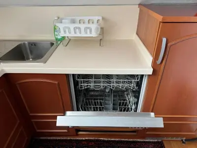 a dishwasher with dishes in it in a kitchen at Vila Majda Elegant Apartments with Prime Location and Parking in Ljubljana