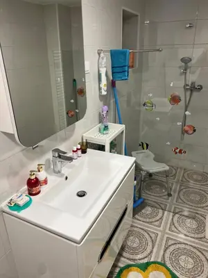 a white bathroom with a sink and a shower at Holiday house Gradišče in Škofljica