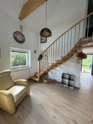 a living room with a couch and a staircase at Holiday house Gradišče in Škofljica