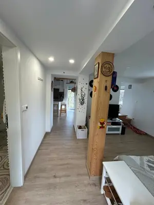 a room with a hallway with a clock on the wall at Holiday house Gradišče in Škofljica