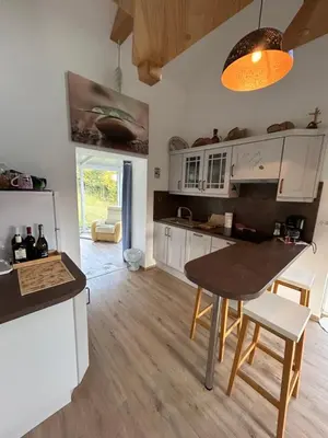 a kitchen with white cabinets and a table and chairs at Holiday house Gradišče in Škofljica