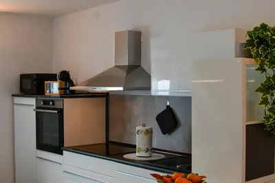a kitchen with a stove and a stove top oven at Piramida Kras in Komen