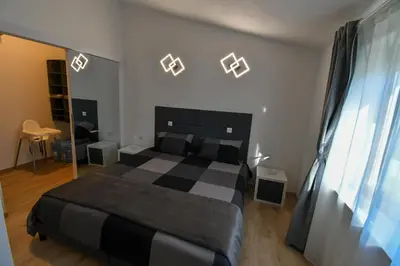 a bedroom with a black and white bed and lights at Piramida Kras in Komen