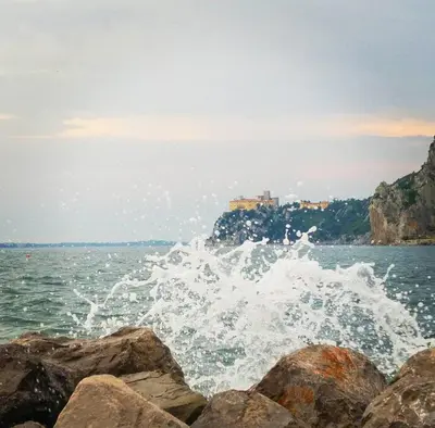 a body of water with rocks in the foreground at Piramida Kras in Komen