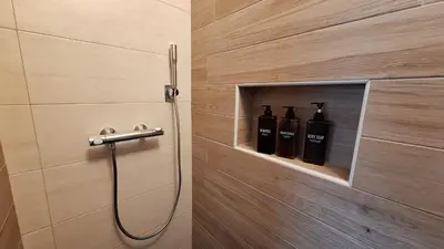 two bottles of wine in a niche in a bathroom at Piramida Kras in Komen