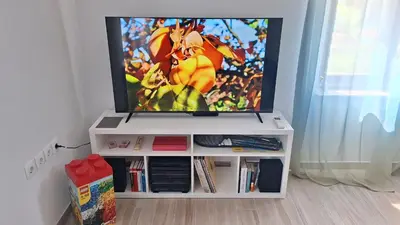 a flat screen tv on a white entertainment center at Piramida Kras in Komen
