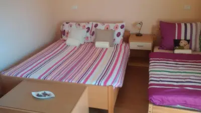 a small childs bedroom with a bed and a table at Osterija Na Planinci in Divača