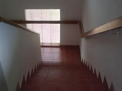 an empty hallway with a staircase and a window at Osterija Na Planinci in Divača
