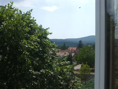 a view from the window of a house with trees at Osterija Na Planinci in Divača