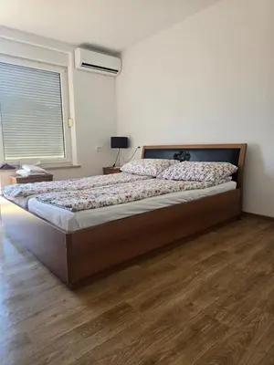 a large bed in a bedroom with a wooden floor at Halalko Konak in Šmarje-Sap