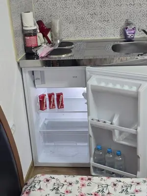 an open refrigerator with its door open in a kitchen at Halalko Konak in Šmarje-Sap