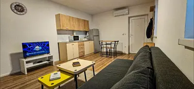 a living room with a couch and a kitchen at Rezidenca Erjavec in Notranje Gorice