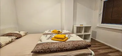 two beds in a room with yellow towels on them at Rezidenca Erjavec in Notranje Gorice