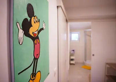 a painting of mickey mouse on the wall of a hallway at Rezidenca Erjavec in Notranje Gorice